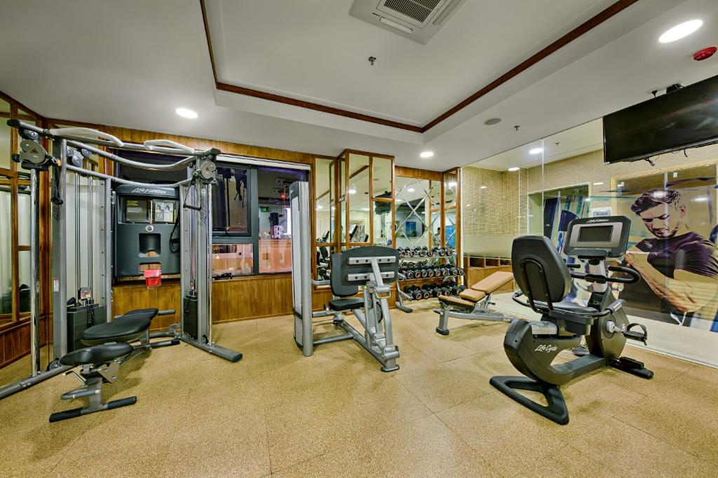 A second view of the gym showing strength equipment and a stationary bike.