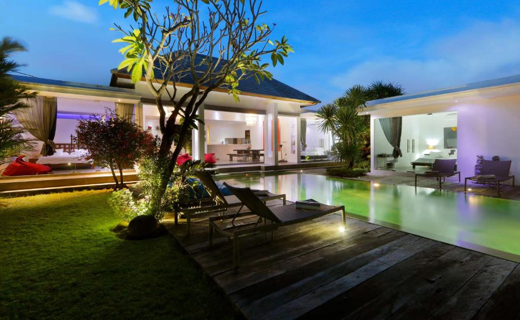 a villa with a swimming pool at night at Villa Bahia by Optimum Bali Villas in Seminyak