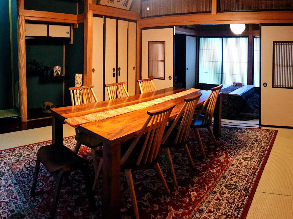a large wooden table and chairs in a room at K's Villa Hida-an in Takayama