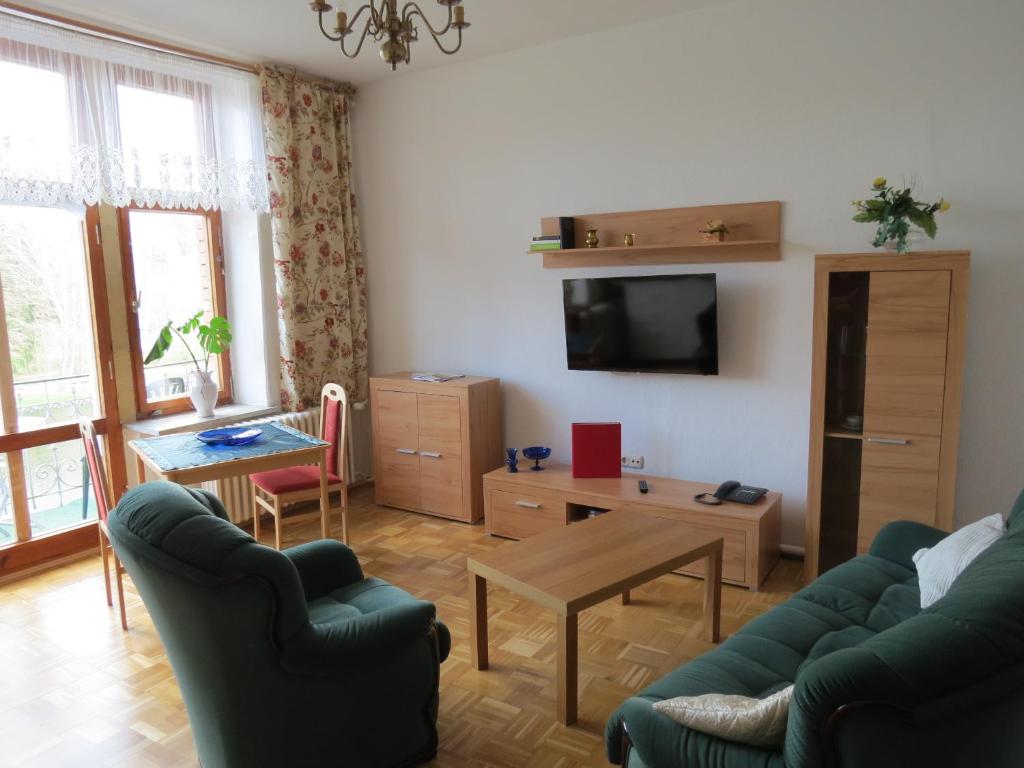 a living room with a couch and a table at Hotel-Pension SCHLOSS -MIRAMAR in Bad Elster