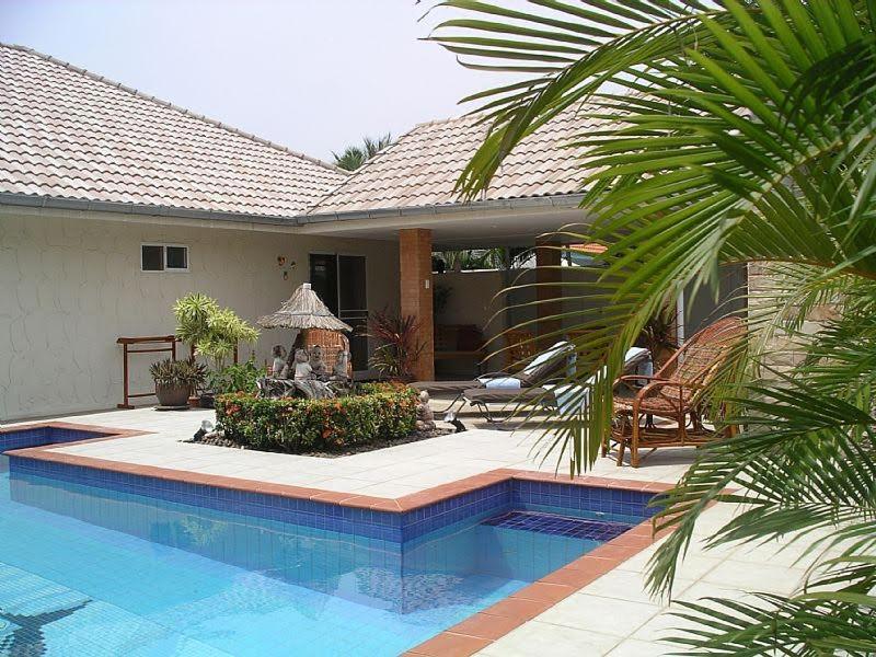 a house with a swimming pool in front of a house at Villa Baansiesom in Sam Roi Yot