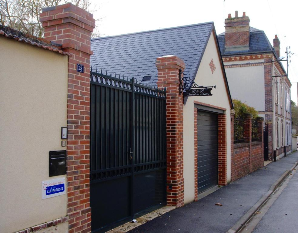 a black gate on the side of a brick building at les crépinières in Chartres