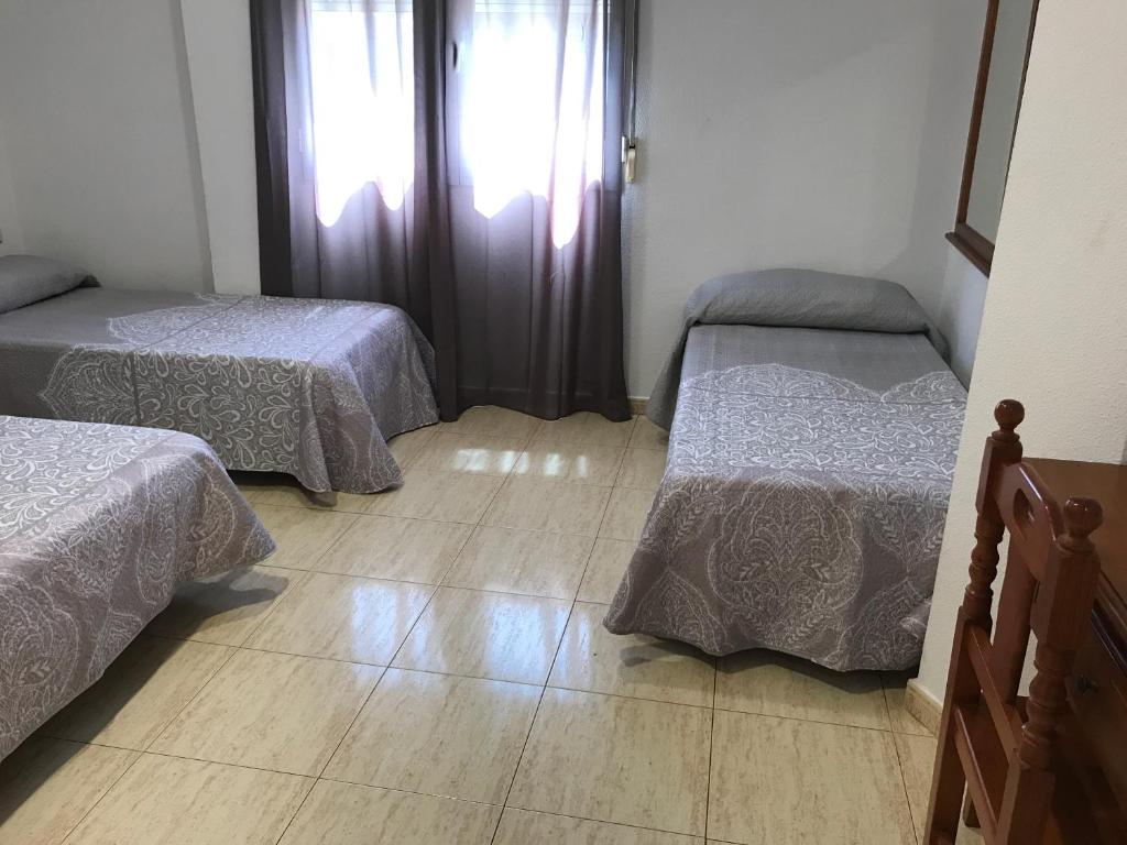 Postel nebo postele na pokoji v ubytování Hostal 82