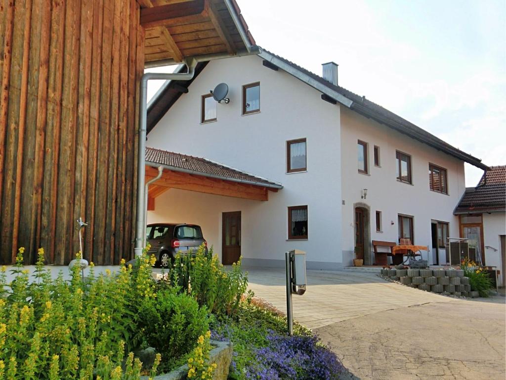 a house with a car parked in front of it at Charming holiday flat in the Bavarian Forest in Gleißenberg