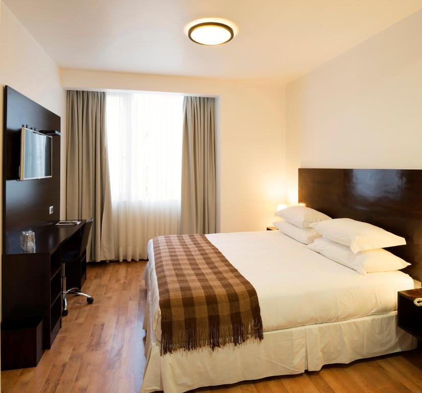 En eller flere senge i et værelse på Hotel Casa Beltran