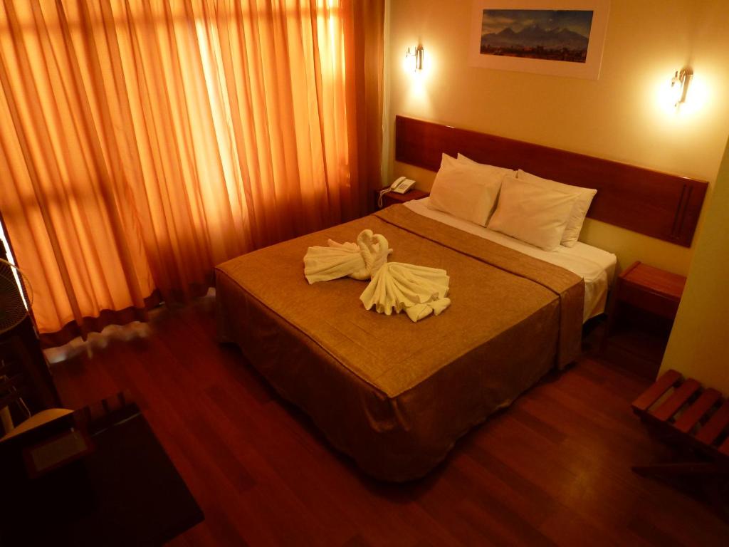 Postel nebo postele na pokoji v ubytování Hostal Qoyllurwasi