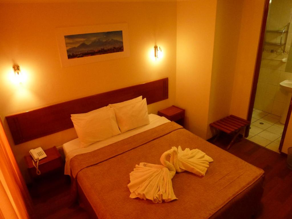Postel nebo postele na pokoji v ubytování Hostal Qoyllurwasi