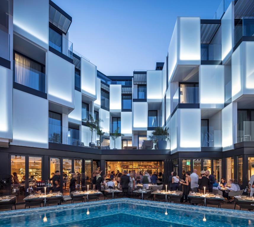 an exterior view of a building with a swimming pool at Sir Joan Hotel, part of Sircle Collection in Ibiza Town