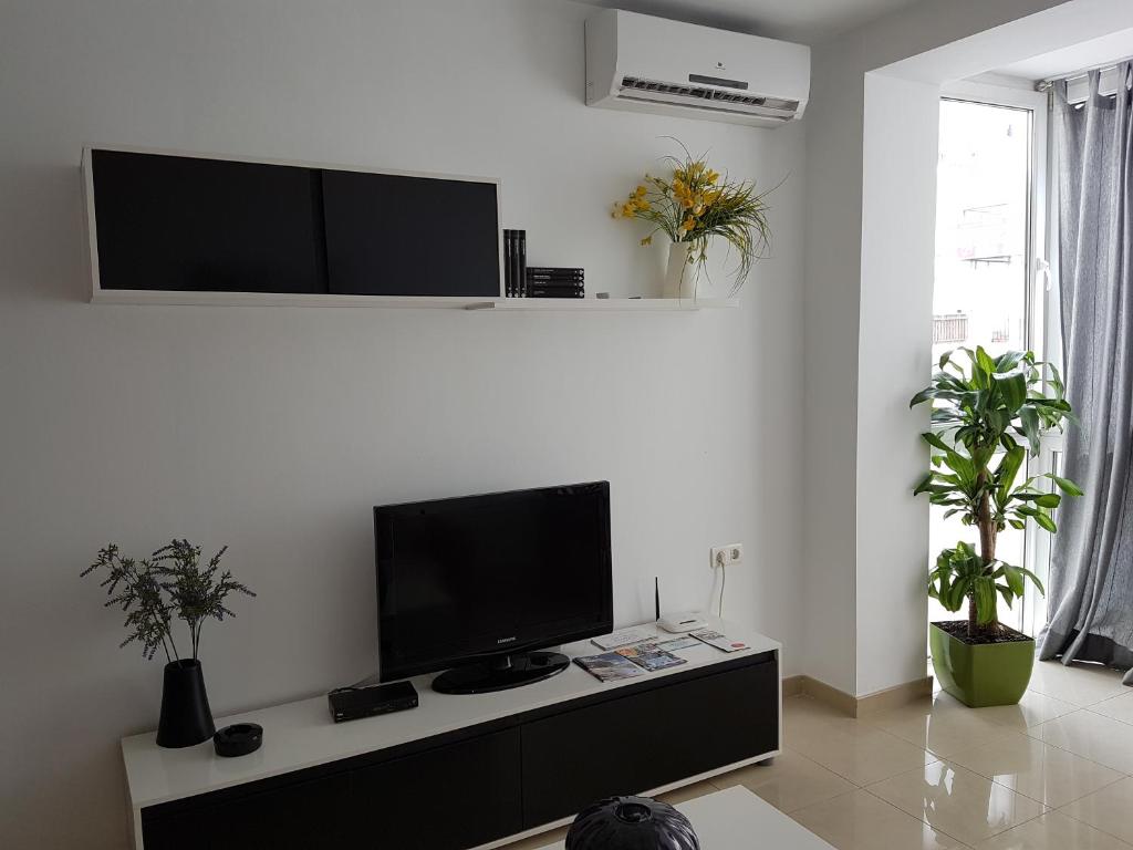 a living room with a flat screen tv on a wall at Apartamento en el centro de Nerja in Nerja