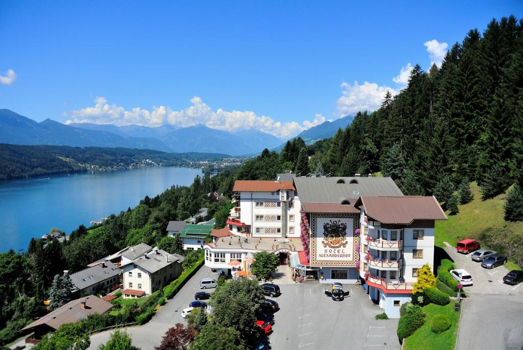 a town on a hill next to a body of water at Hotel Alexanderhof in Millstatt