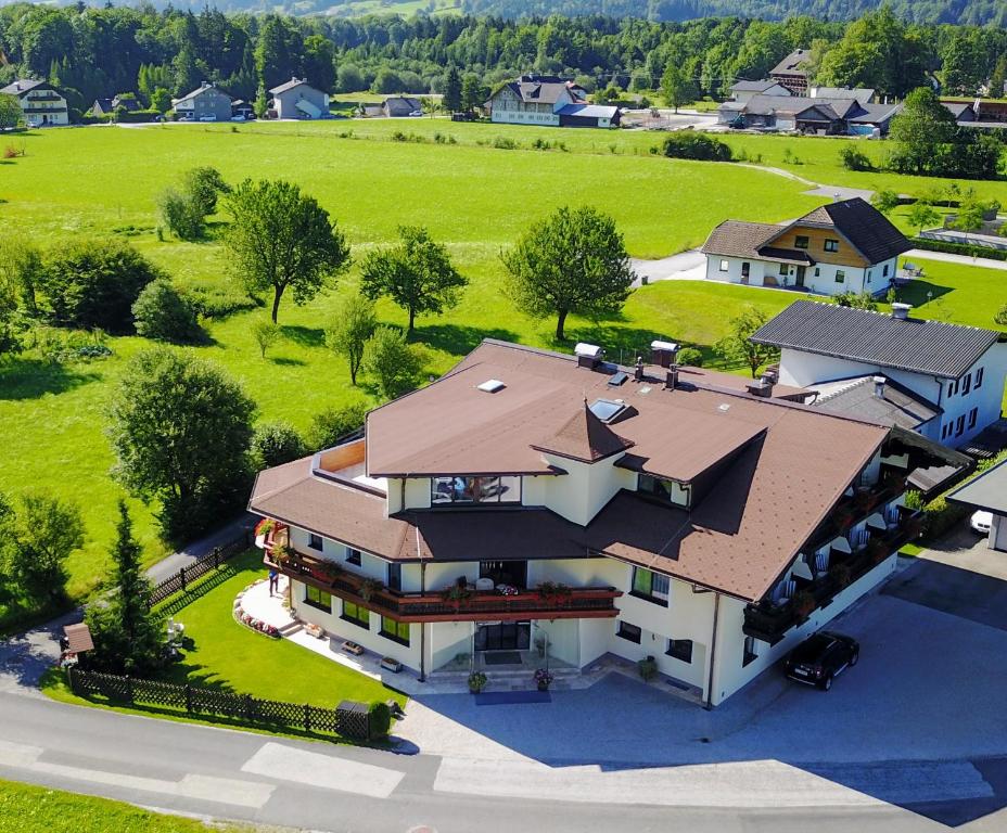an aerial view of a large house with a roof at Pension Schlömmer in Sankt Gilgen