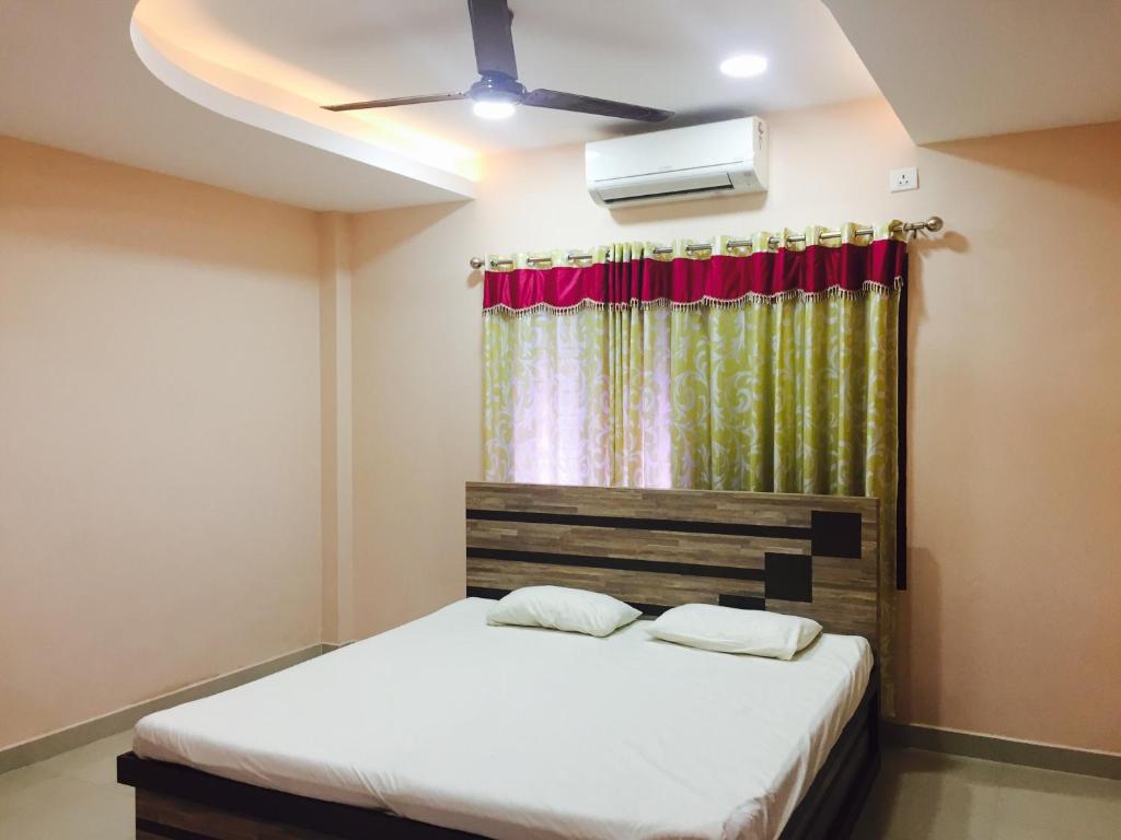 a bedroom with a bed and a window at Mega Tourist Home Palarivattom in Cochin
