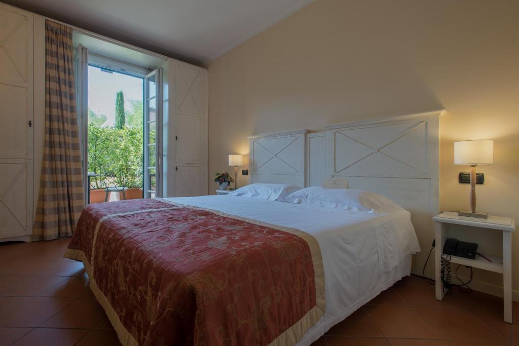 Postel nebo postele na pokoji v ubytování Hotel Villa Cappugi