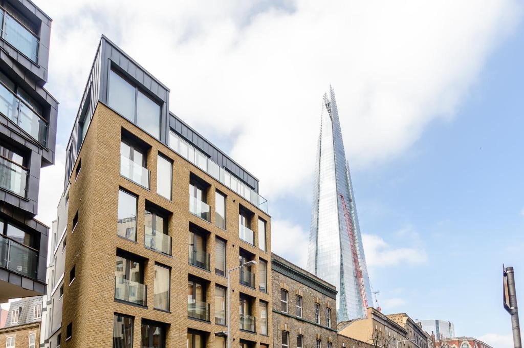 a view of the shard from the city of london at Tooley Street Apartments by Viridian Apartments in London