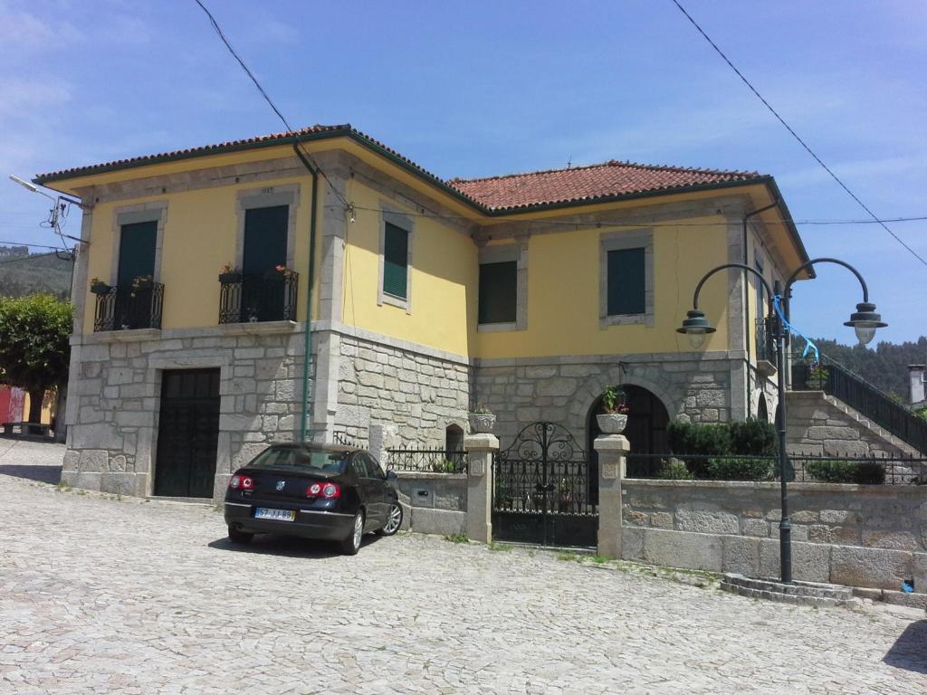 a car parked in front of a house at Casa São João in São João da Serra