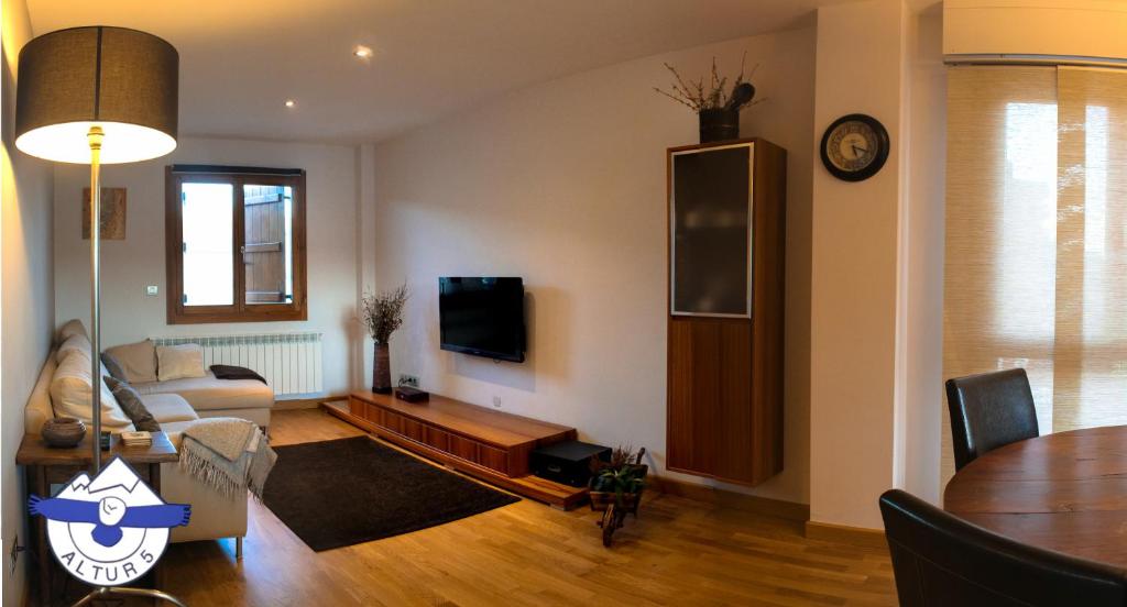 a living room with a couch and a table at Altur 5 Jaca in Jaca