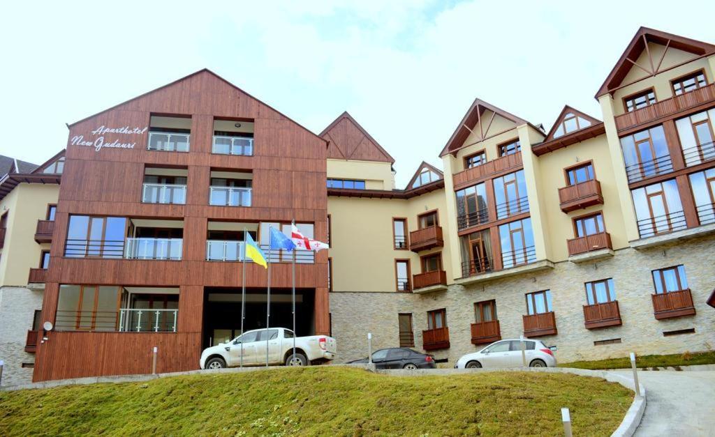 un gran edificio con coches estacionados frente a él en New Gudauri Redco - Block 1 apartment 418, en Gudauri