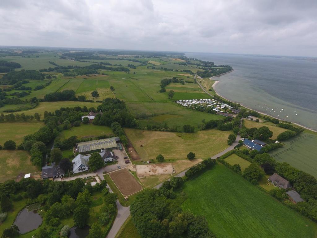 an aerial view of a house next to the ocean at Lindenhof Habernis in Steinberg