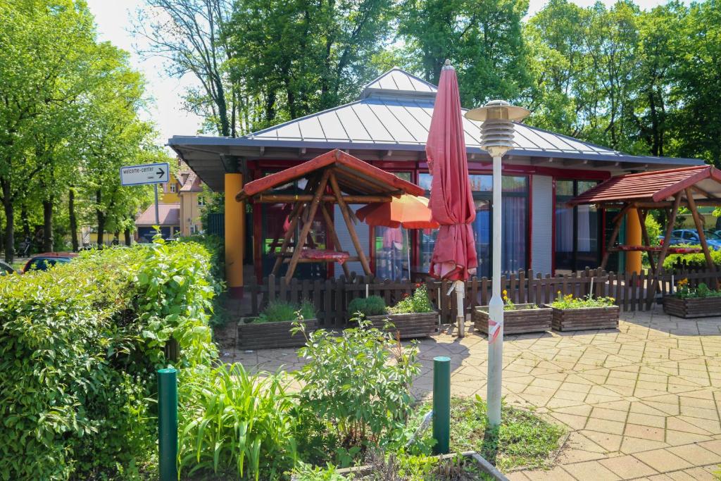 un bâtiment avec un parapluie rouge devant lui dans l'établissement 1a Ferienwohnung, à Weimar