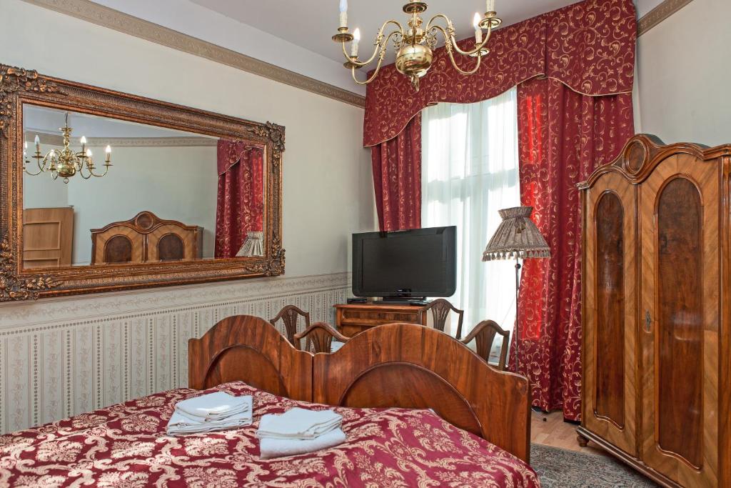 Televízia a/alebo spoločenská miestnosť v ubytovaní Metropolitan Apartments