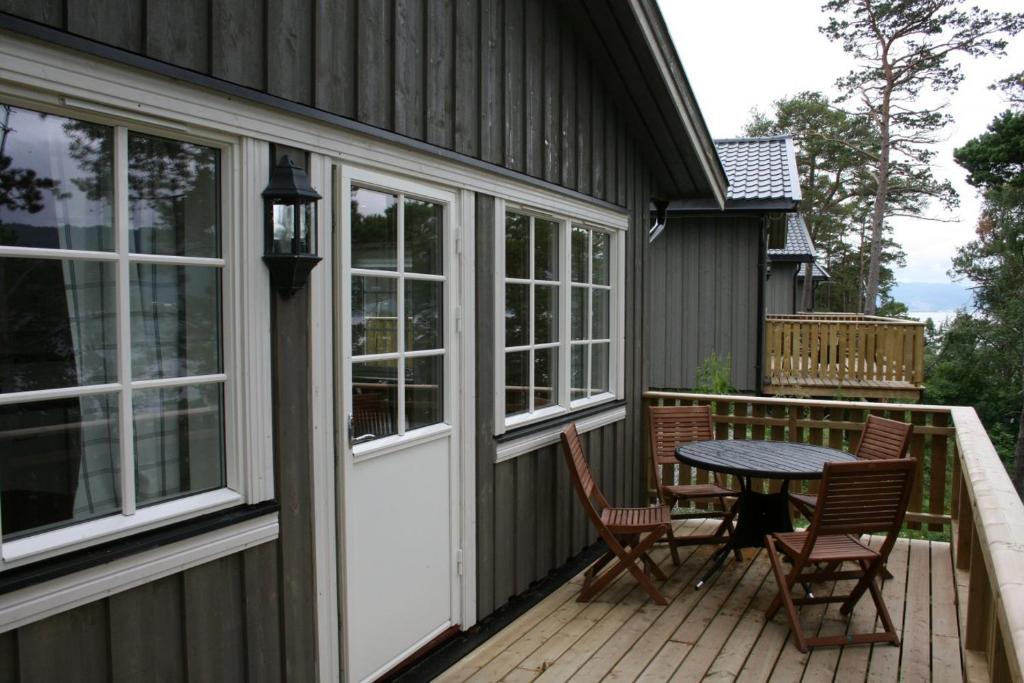 a patio with a table and chairs on a deck at Tråsåvika Camping in Viggja