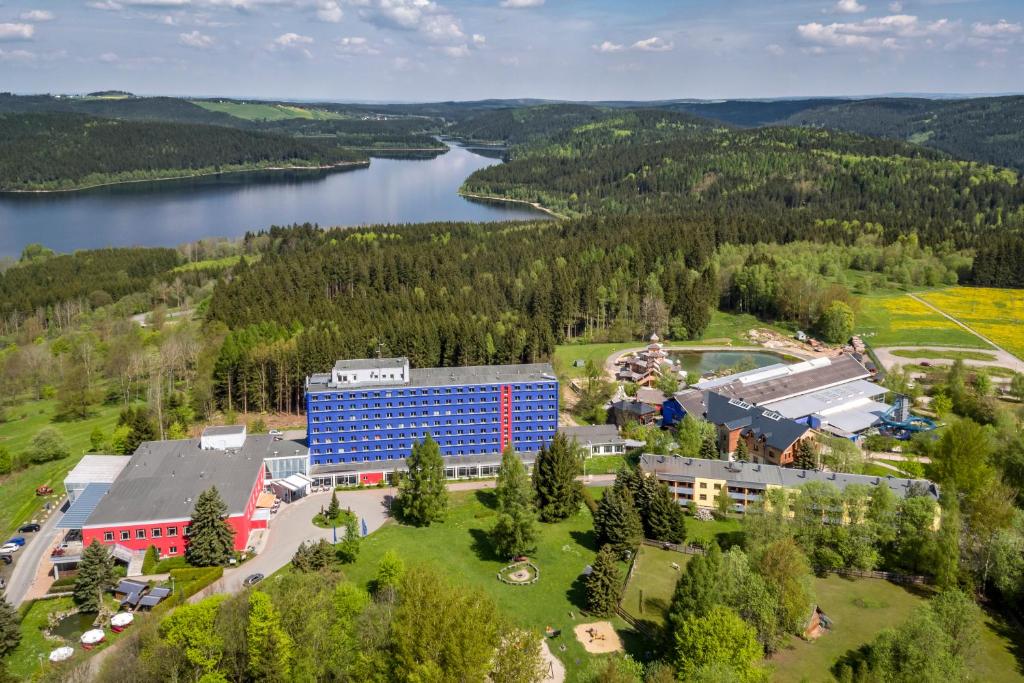an aerial view of a building next to a lake at Hotel Am Bühl in Eibenstock