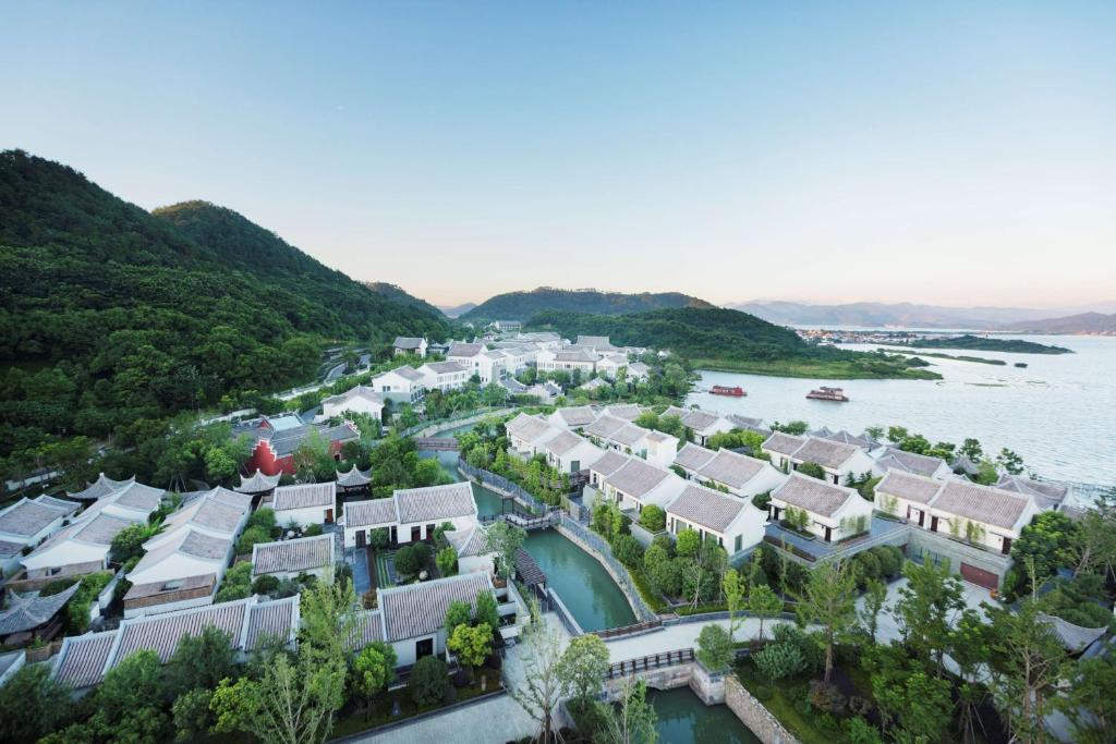 an aerial view of a village next to the water at Park Hyatt Ningbo Resort & Spa in Ningbo