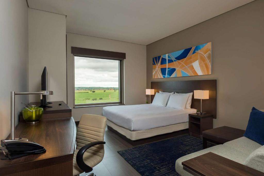 a hotel room with a bed and a window at Hyatt Place Sao Jose do Rio Preto in Sao Jose do Rio Preto