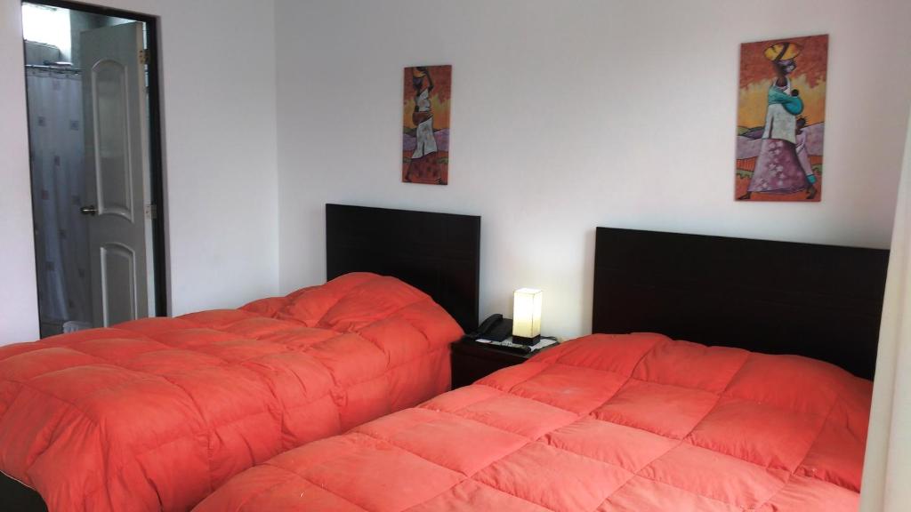 Postel nebo postele na pokoji v ubytování Residencial Carlos