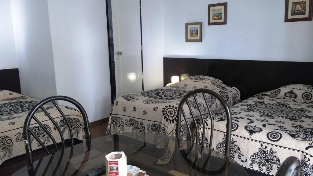 Postel nebo postele na pokoji v ubytování Residencial Carlos