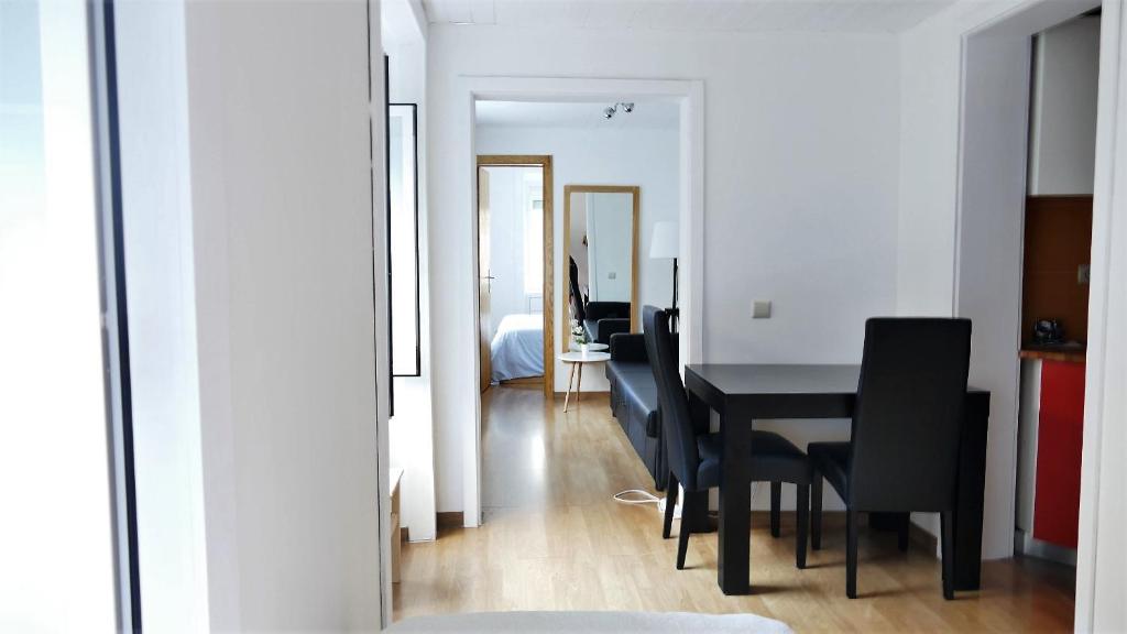 a dining room with a black table and black chairs at EZY Ramos apartment Alfama in Lisbon