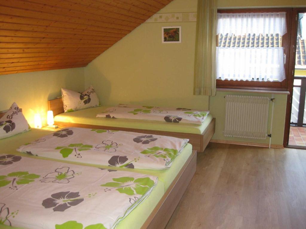a bedroom with two beds and a window at Haus Rehblick in Bräunlingen