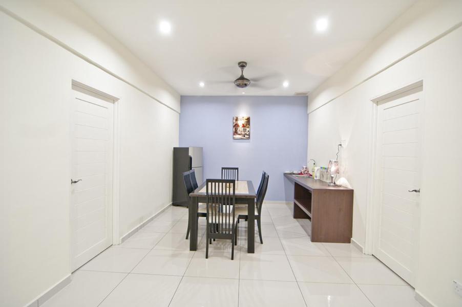 a dining room with a table and chairs and a desk at My Jonker Homes in Malacca