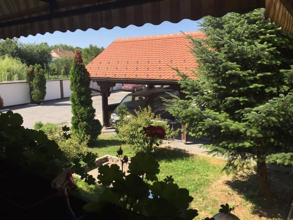 a gazebo with a red roof in a yard at Business Club in Szlatina