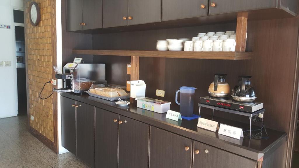 a kitchen with a counter with a coffee maker at Sun Fog Hotel in Yuchi