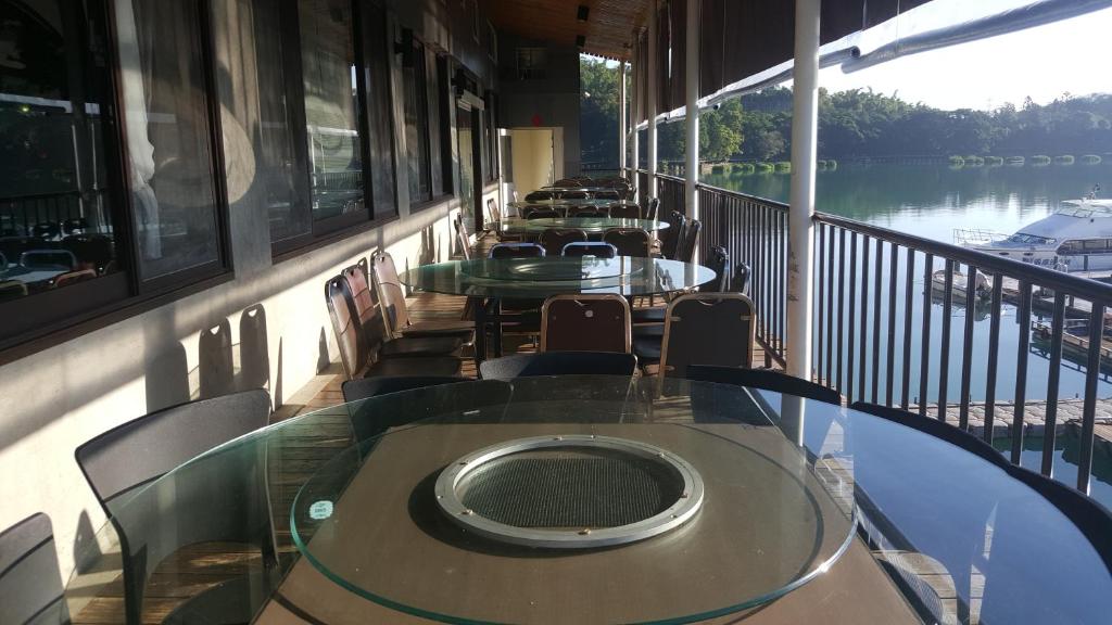 a row of tables and chairs on a balcony at Sun Fog Hotel in Yuchi