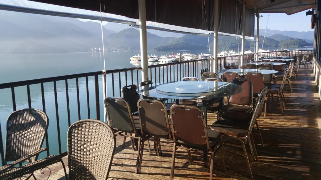 a row of tables and chairs on a balcony at Sun Fog Hotel in Yuchi