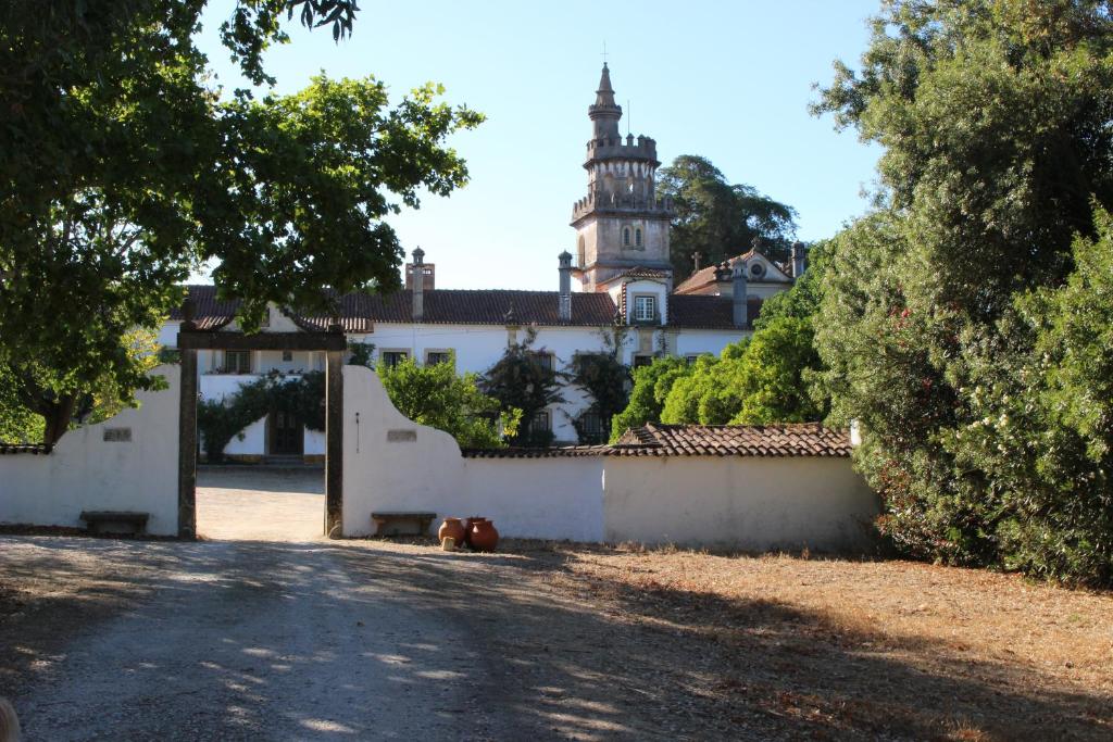 a white building with a clock tower in the background at Quinta do Valle in Tomar