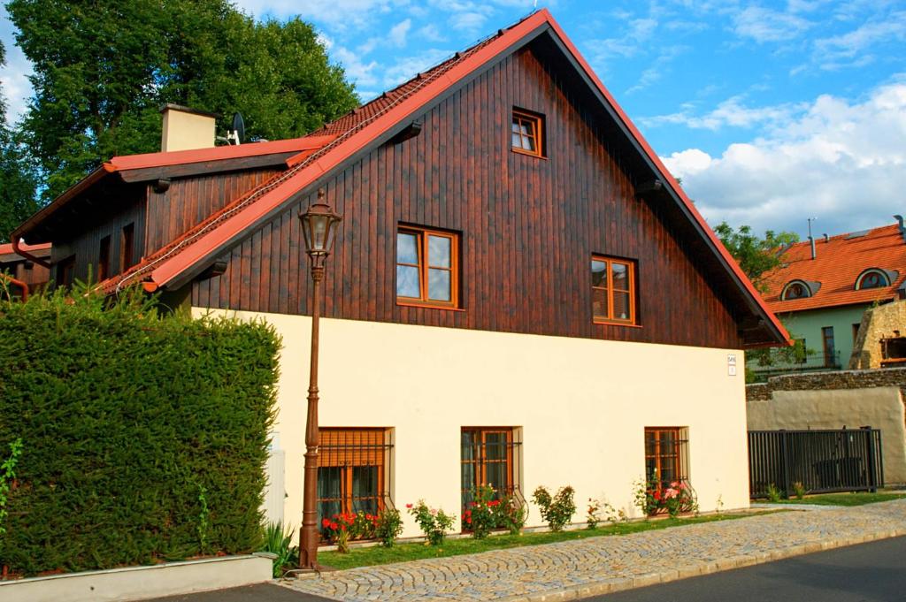 a large wooden house with a red roof at Vila Pod Bránou in Poprad