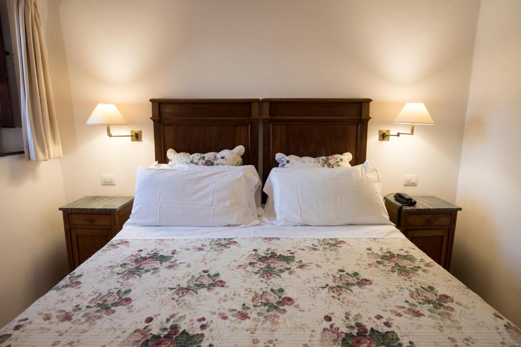 Postel nebo postele na pokoji v ubytování Hotel Lucrezia