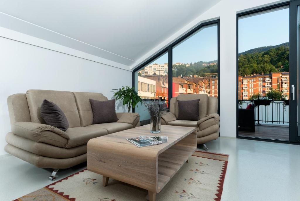 a living room with a couch and a coffee table at BA Apartments in Sarajevo