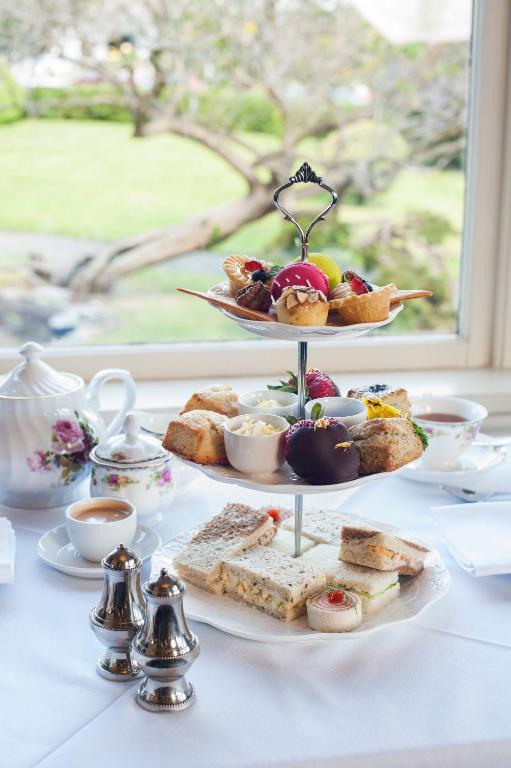 a white table with a plate of food on a table at Pendray Inn and Tea House in Victoria