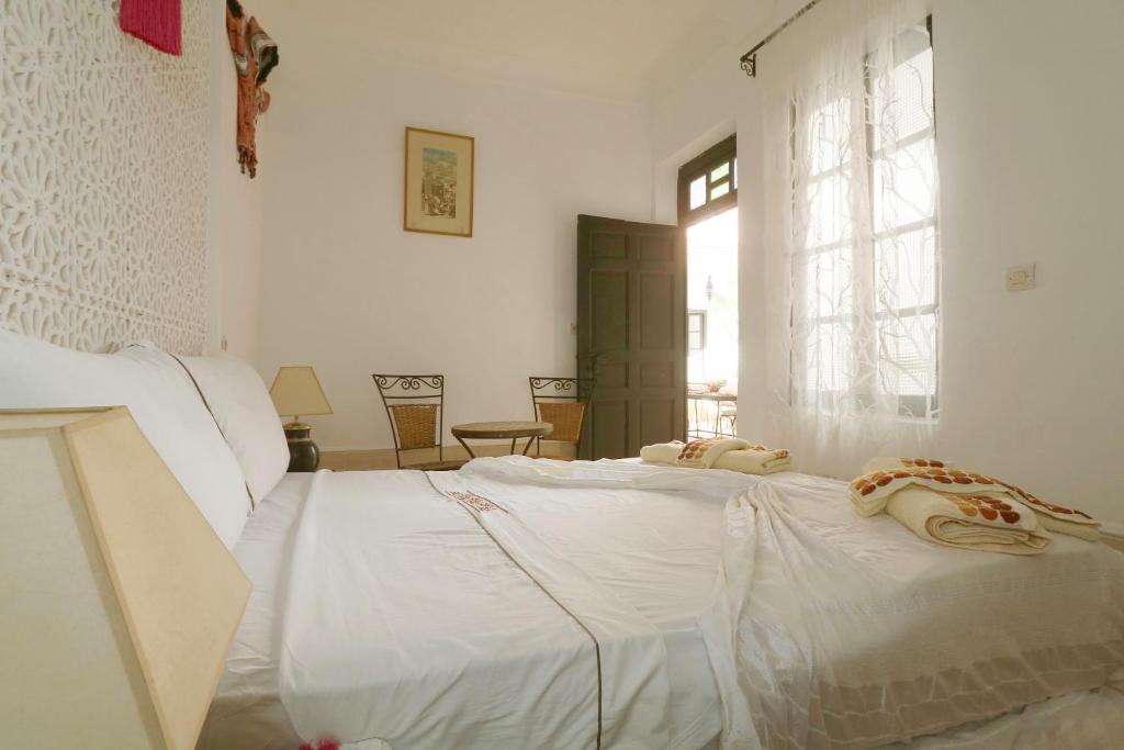 Postel nebo postele na pokoji v ubytování Riad Ibiza Star