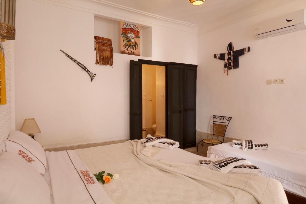 Postel nebo postele na pokoji v ubytování Riad Ibiza Star