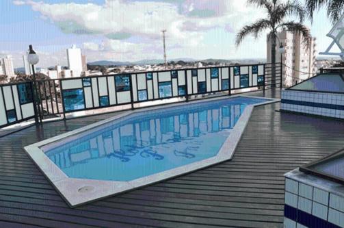 a large swimming pool on the roof of a building at Hotel Plaza Inn Flat Residence in Alfenas