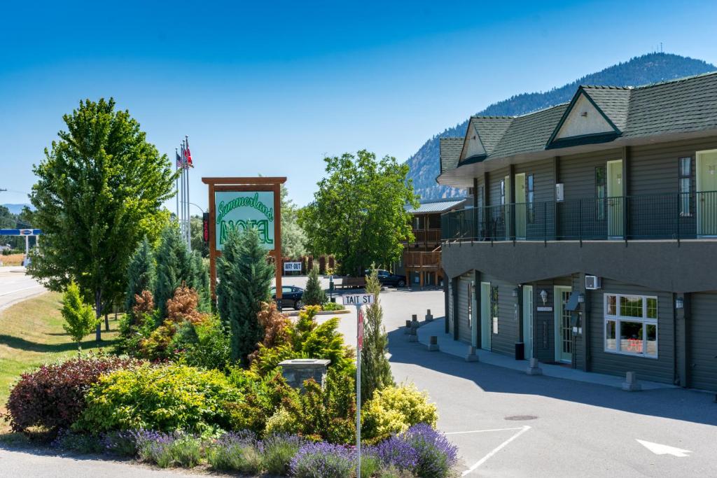 a building in a town with flowers in front of it at Summerland Motel in Summerland