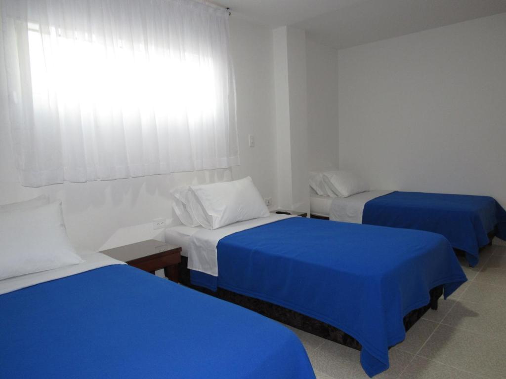 Postel nebo postele na pokoji v ubytování Hotel Getsemaní BGA
