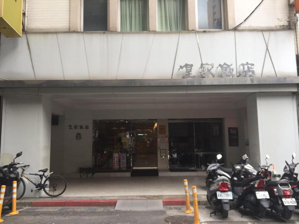 a group of motorcycles parked in front of a building at Royal Hotel in Taipei