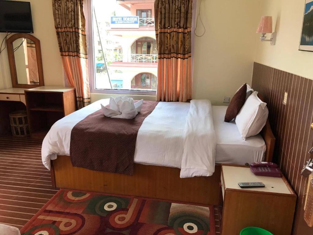 Postel nebo postele na pokoji v ubytování Hotel Himalayan Inn