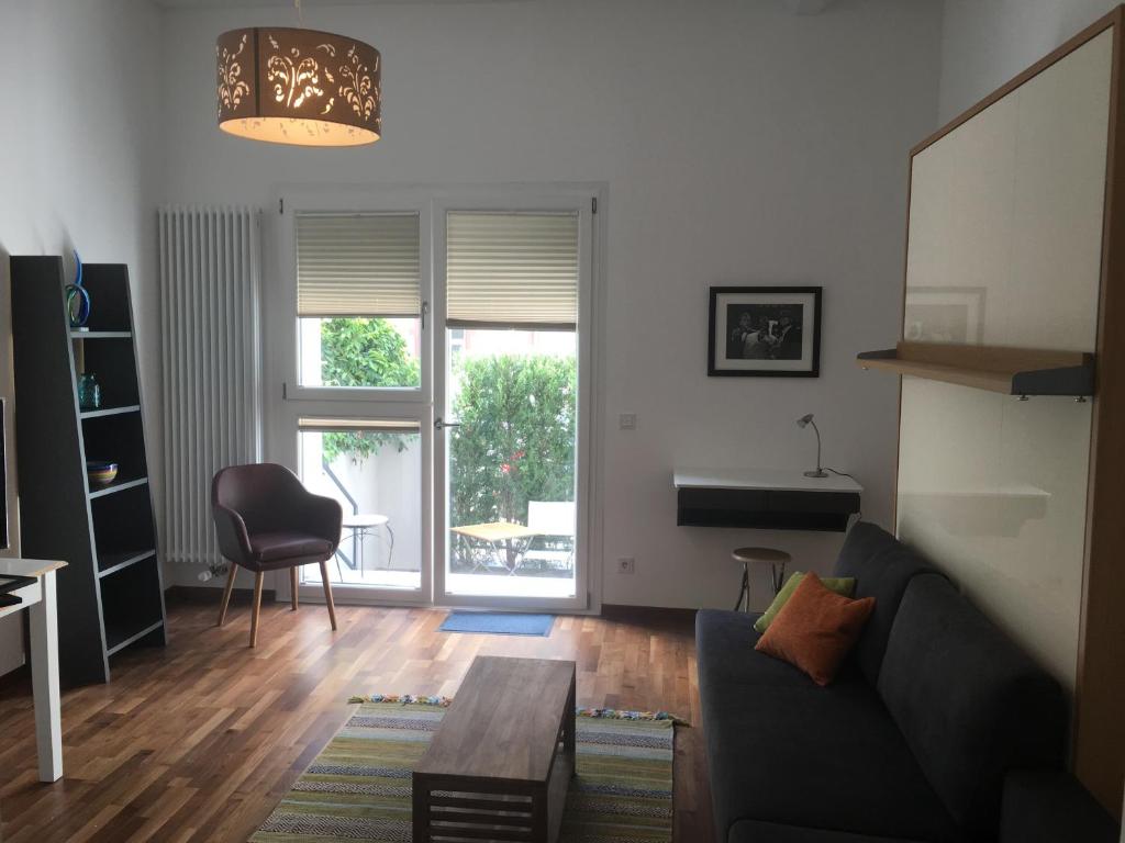 a living room with a couch and a table at Central Suites Frankfurt in Frankfurt